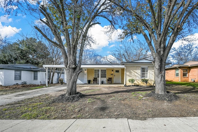 ranch-style home with a porch, a carport, and a garage