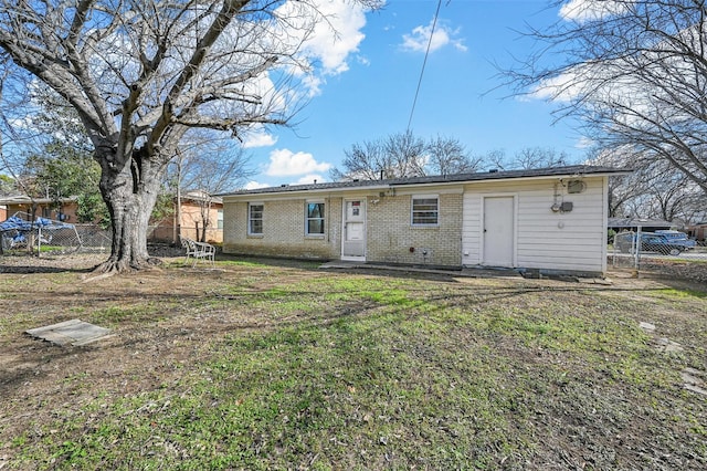 back of property featuring a yard