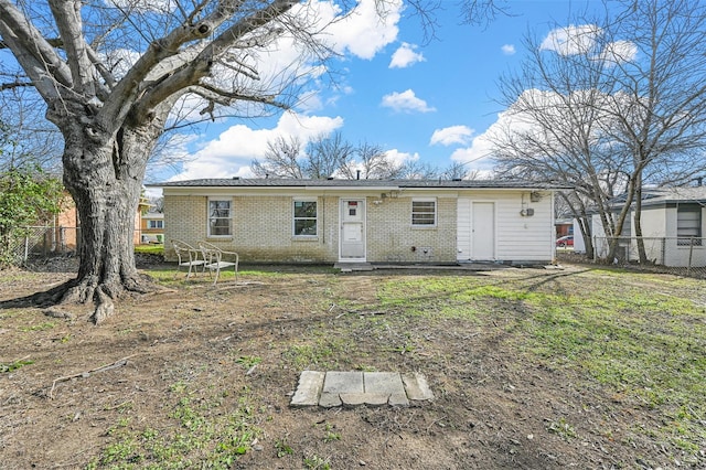 rear view of property with a lawn