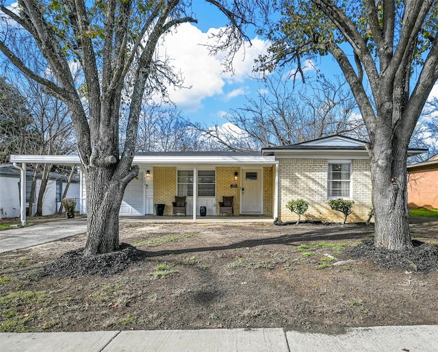 ranch-style home featuring a garage and covered porch