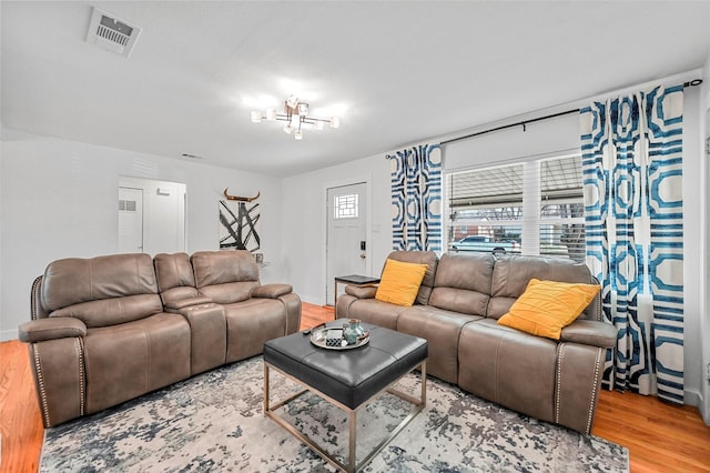 living room featuring hardwood / wood-style floors and a chandelier