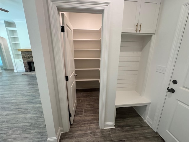 686 Newburyport St, Blanchard, LA 71107 - mudroom featuring dark wood finished floors, built in shelves, a fireplace, and baseboards