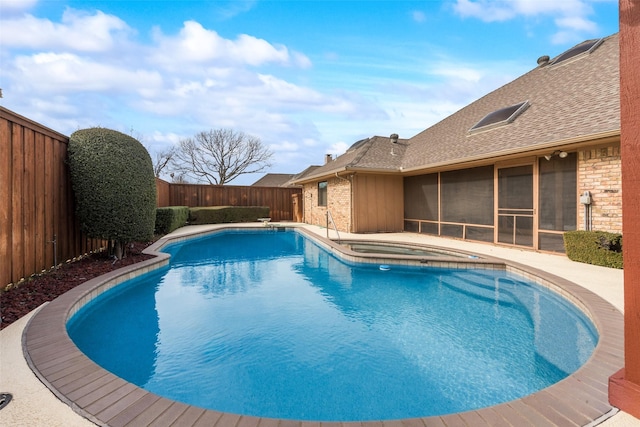 view of pool featuring an in ground hot tub and a sunroom