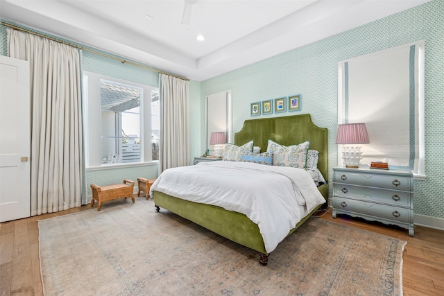 bedroom with ceiling fan and wood-type flooring