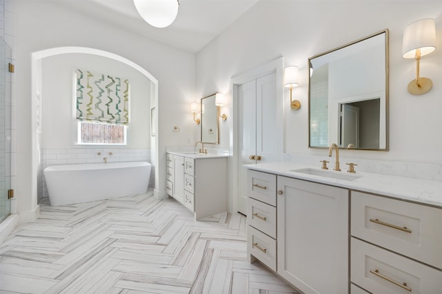 bathroom with a bath and vanity