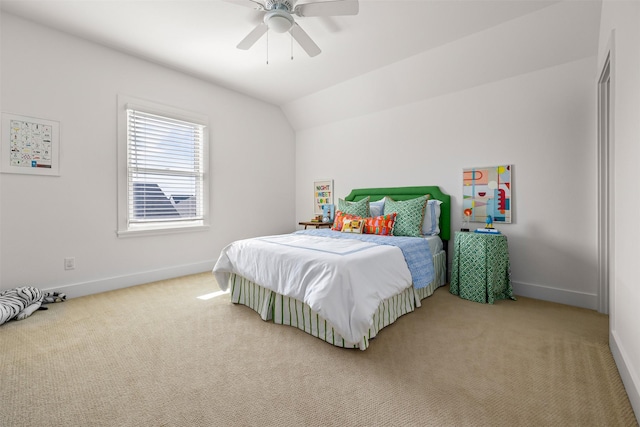 bedroom with ceiling fan, carpet flooring, and lofted ceiling