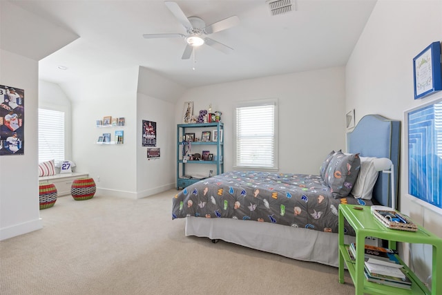 bedroom featuring light colored carpet, vaulted ceiling, and ceiling fan