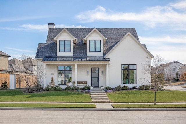 view of front facade featuring a front yard and covered porch