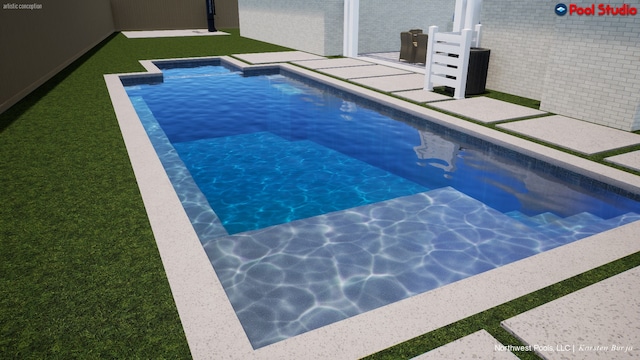 view of swimming pool with a lawn