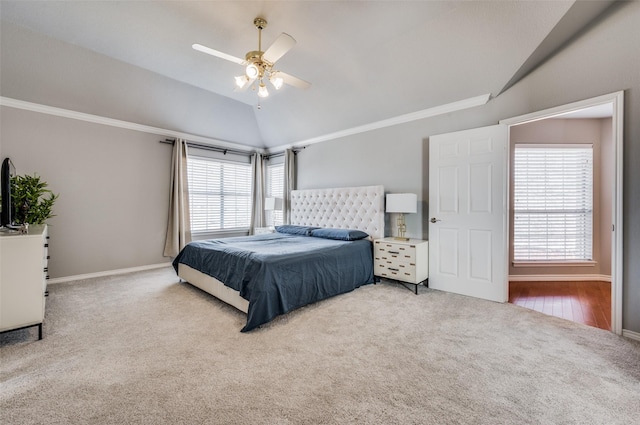 bedroom featuring ceiling fan, vaulted ceiling, ornamental molding, and carpet flooring