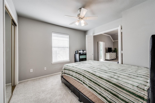 carpeted bedroom featuring ceiling fan, a closet, and vaulted ceiling