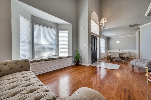 entrance foyer with crown molding and hardwood / wood-style flooring