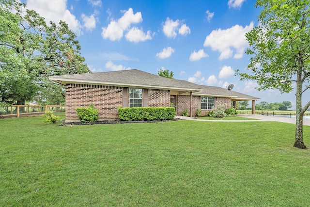 ranch-style home with a front lawn