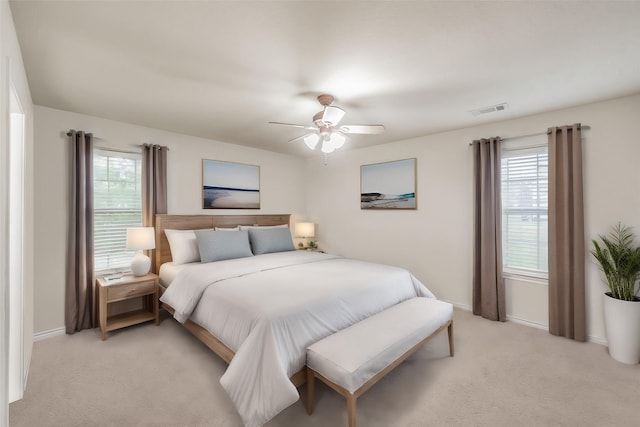 bedroom featuring ceiling fan and light carpet