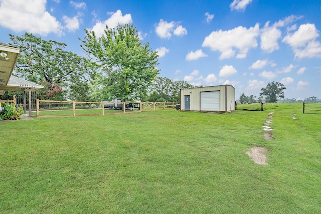 view of yard featuring a rural view, a garage, and an outdoor structure