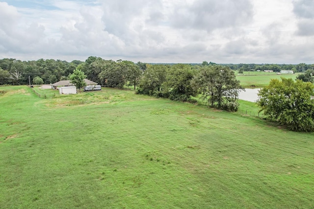 view of yard with a rural view and a water view