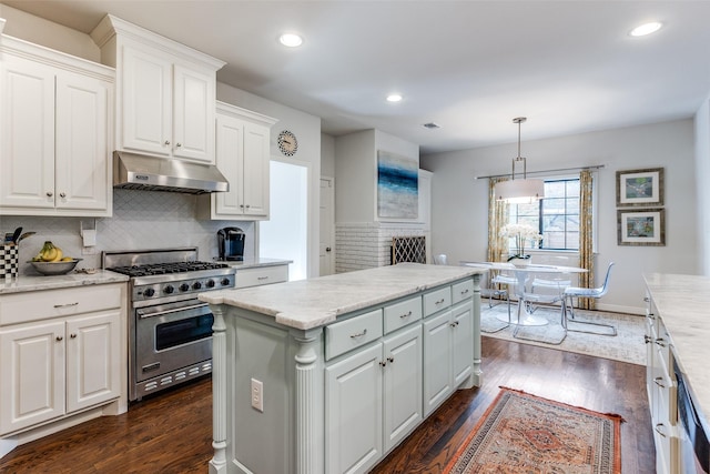 kitchen featuring premium stove, dark hardwood / wood-style flooring, decorative backsplash, white cabinetry, and decorative light fixtures