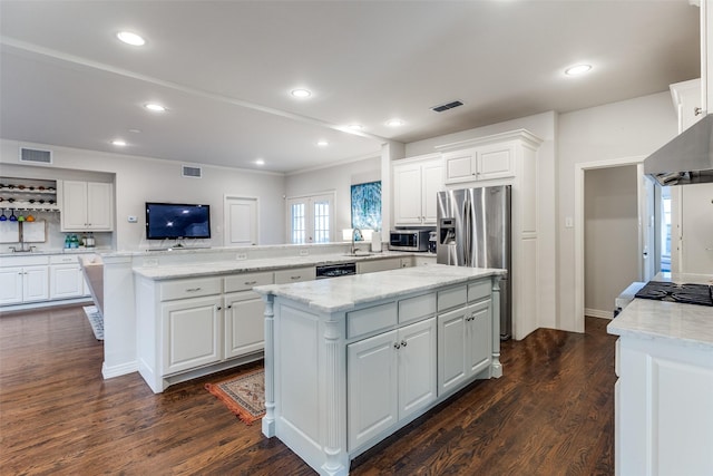 kitchen featuring white cabinetry, dark wood-type flooring, a center island, and kitchen peninsula