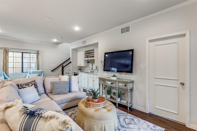 living room featuring ornamental molding, dark hardwood / wood-style floors, and sink