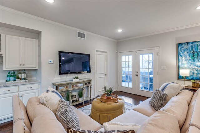 living room featuring french doors, crown molding, and dark hardwood / wood-style floors