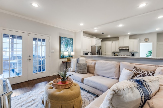 living room with french doors, crown molding, and dark hardwood / wood-style floors