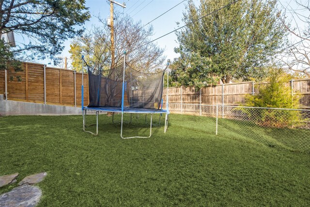 view of yard with a trampoline