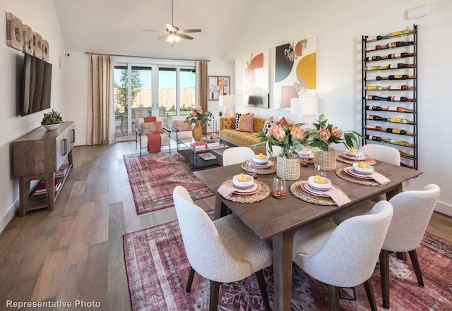 dining room featuring ceiling fan, high vaulted ceiling, and wood-type flooring