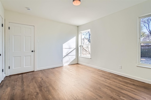 spare room with dark hardwood / wood-style floors