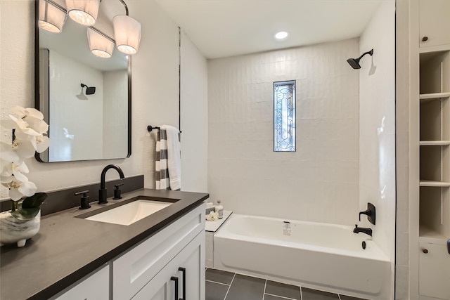 bathroom with vanity, tile patterned flooring, and tiled shower / bath combo