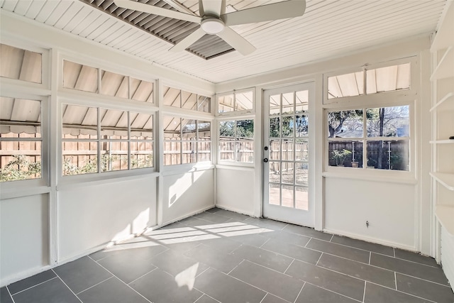 unfurnished sunroom featuring ceiling fan