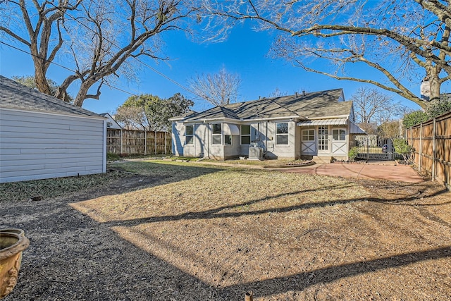 rear view of property with a lawn and a patio area