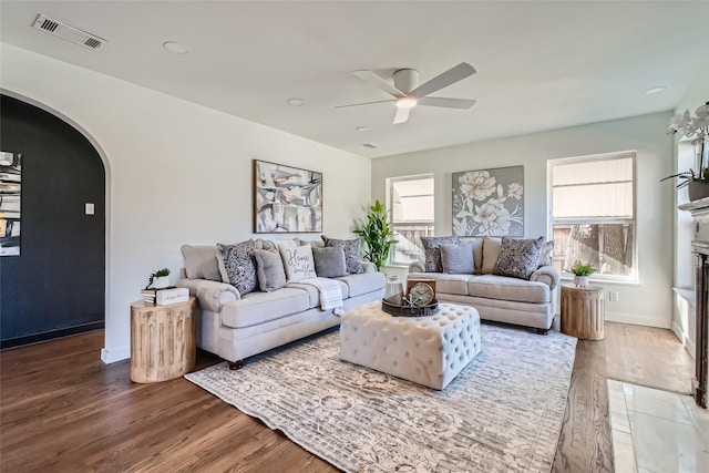 living room with a fireplace, hardwood / wood-style floors, and ceiling fan