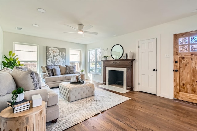 living room featuring ceiling fan and dark hardwood / wood-style floors