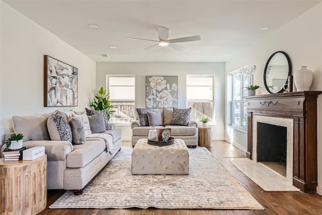 living room featuring wood-type flooring and ceiling fan