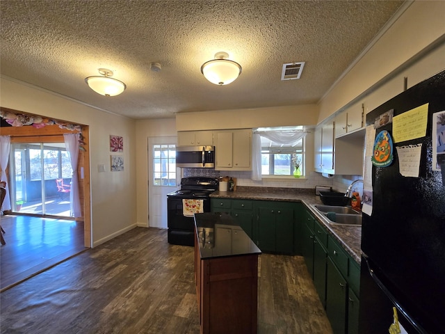 kitchen featuring sink, white cabinets, decorative backsplash, dark hardwood / wood-style floors, and black appliances