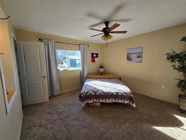 carpeted bedroom featuring a textured ceiling and ceiling fan