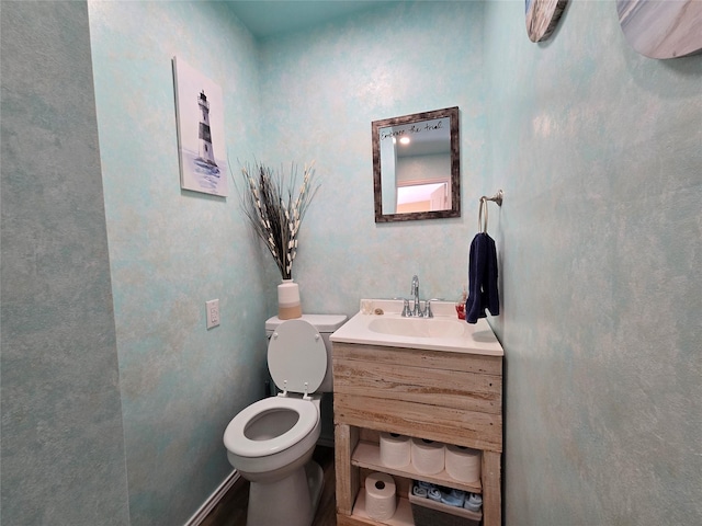 bathroom with toilet and vanity