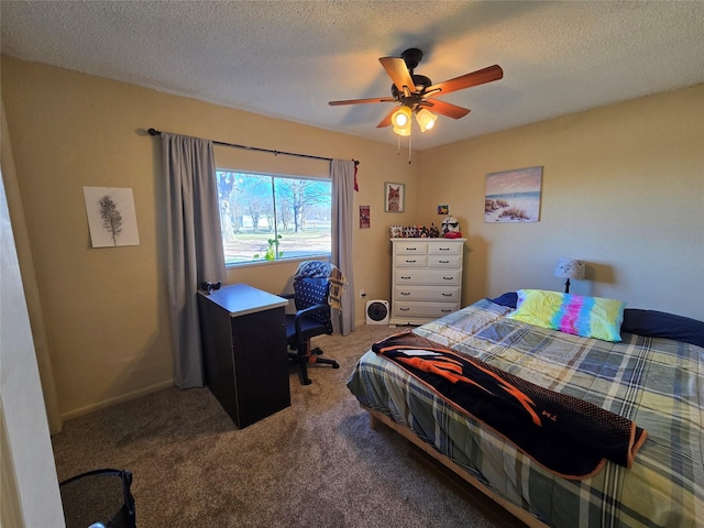 carpeted bedroom with a textured ceiling and ceiling fan