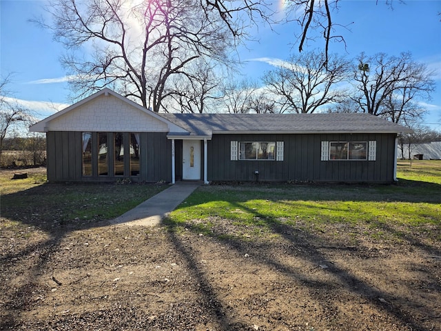 ranch-style home featuring a front yard