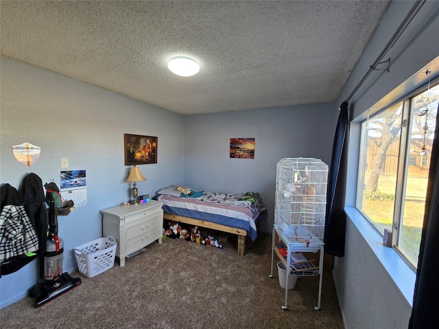 bedroom with a textured ceiling and carpet