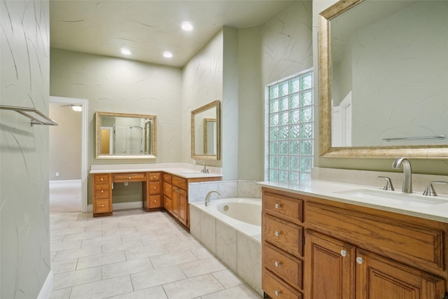 bathroom with vanity, tile patterned flooring, and a relaxing tiled tub