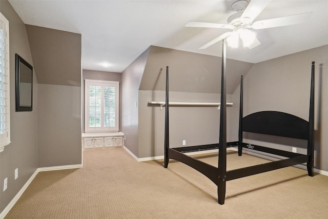 carpeted bedroom featuring vaulted ceiling and ceiling fan