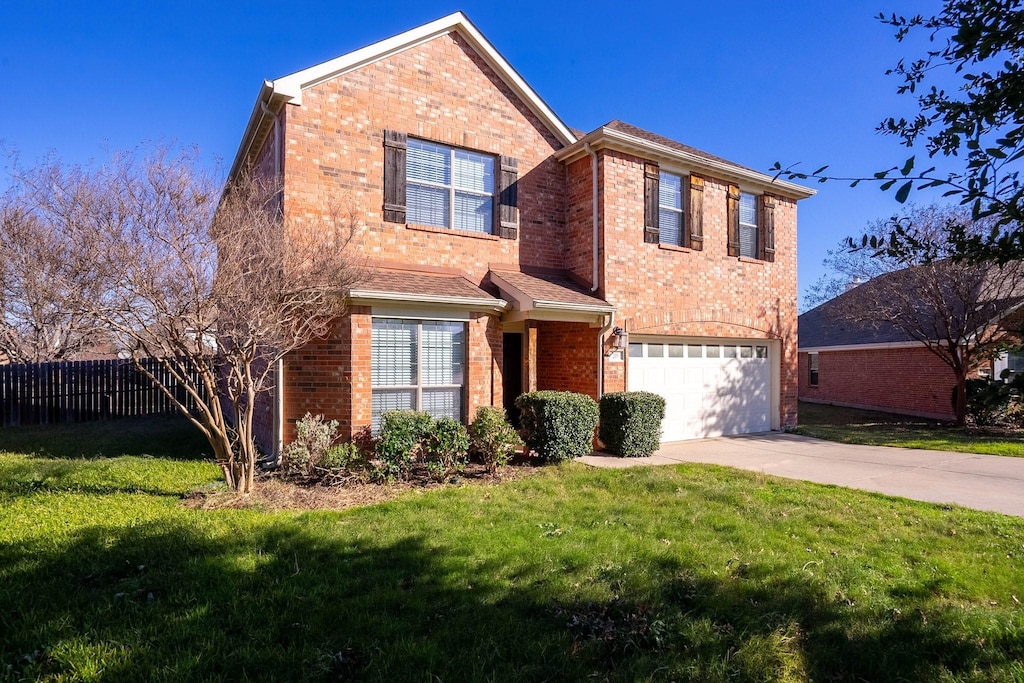 view of front property featuring a front lawn and a garage