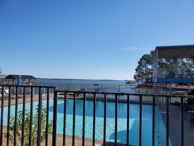 view of pool with a water view