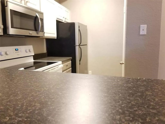 kitchen with white cabinetry and appliances with stainless steel finishes