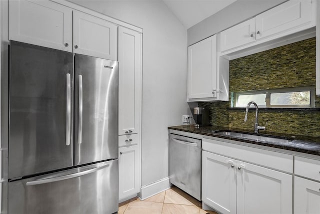 kitchen featuring white cabinets, stainless steel appliances, tasteful backsplash, and sink