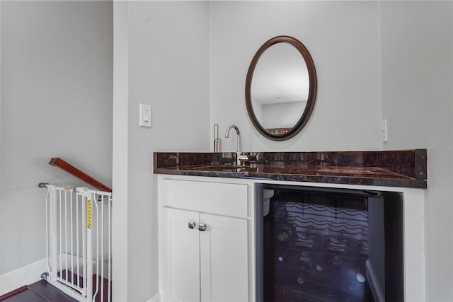 bathroom featuring wine cooler and vanity