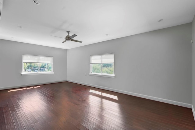 empty room featuring ceiling fan and dark hardwood / wood-style floors