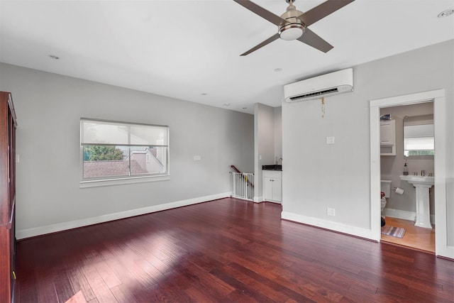 spare room with sink, ceiling fan, dark hardwood / wood-style floors, and an AC wall unit