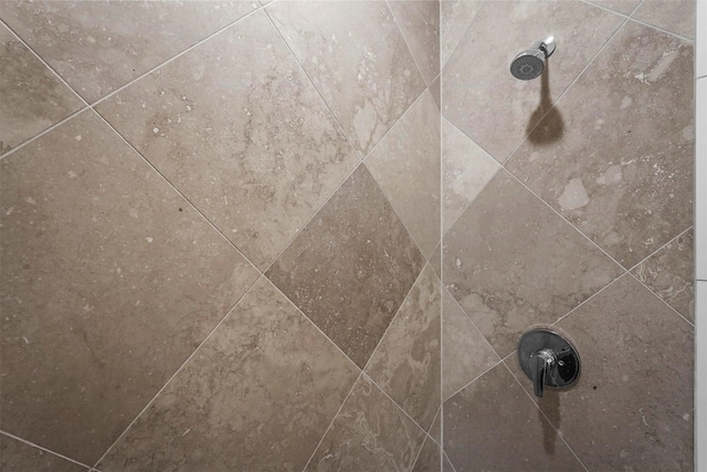 interior details with a tile shower